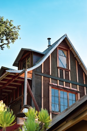 a house with a metal roof and a tree