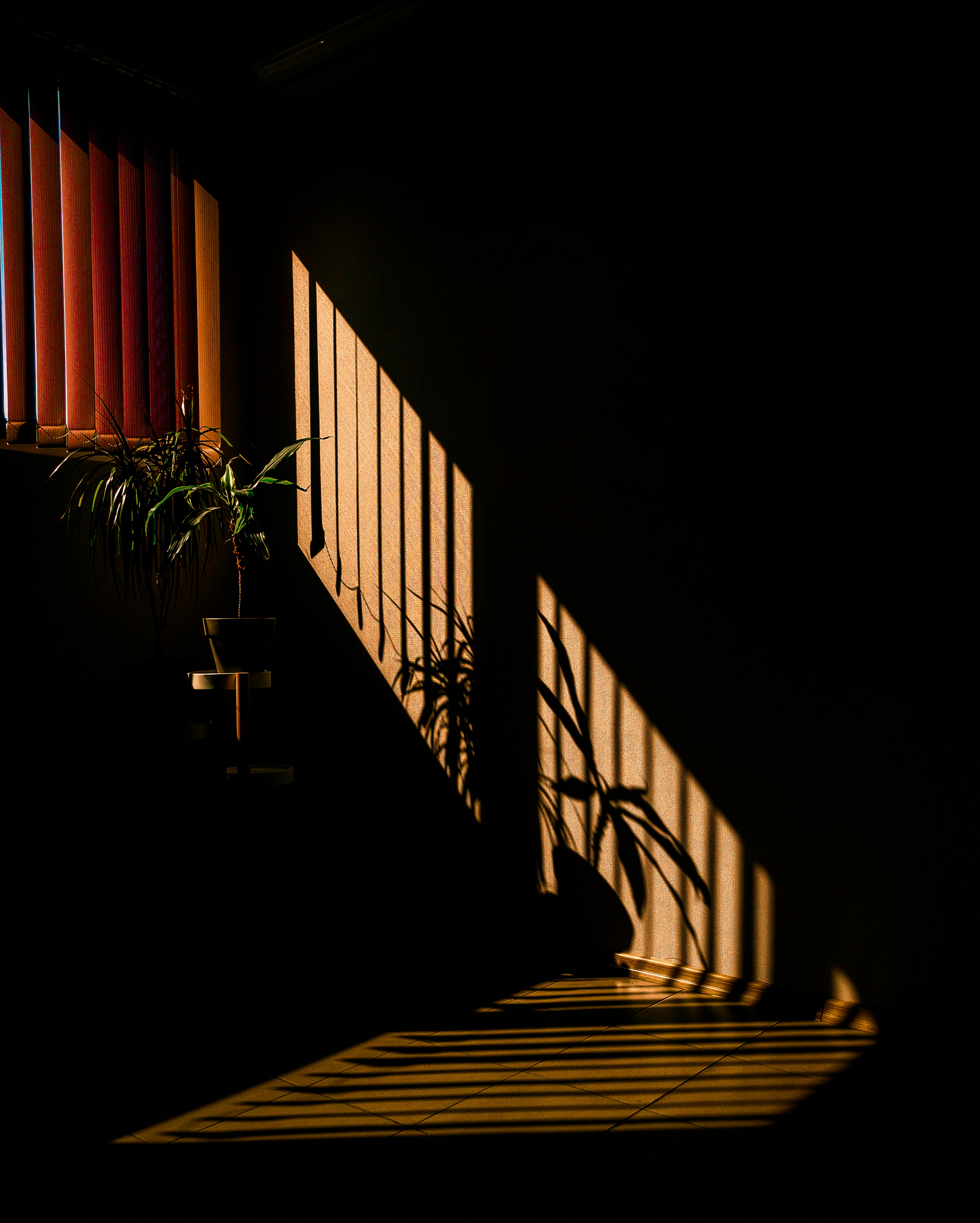 the sun is shining through a window in a dark room