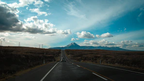 An open road stretching toward mountains under a cinematic sky, symbolizing the gospel journey.