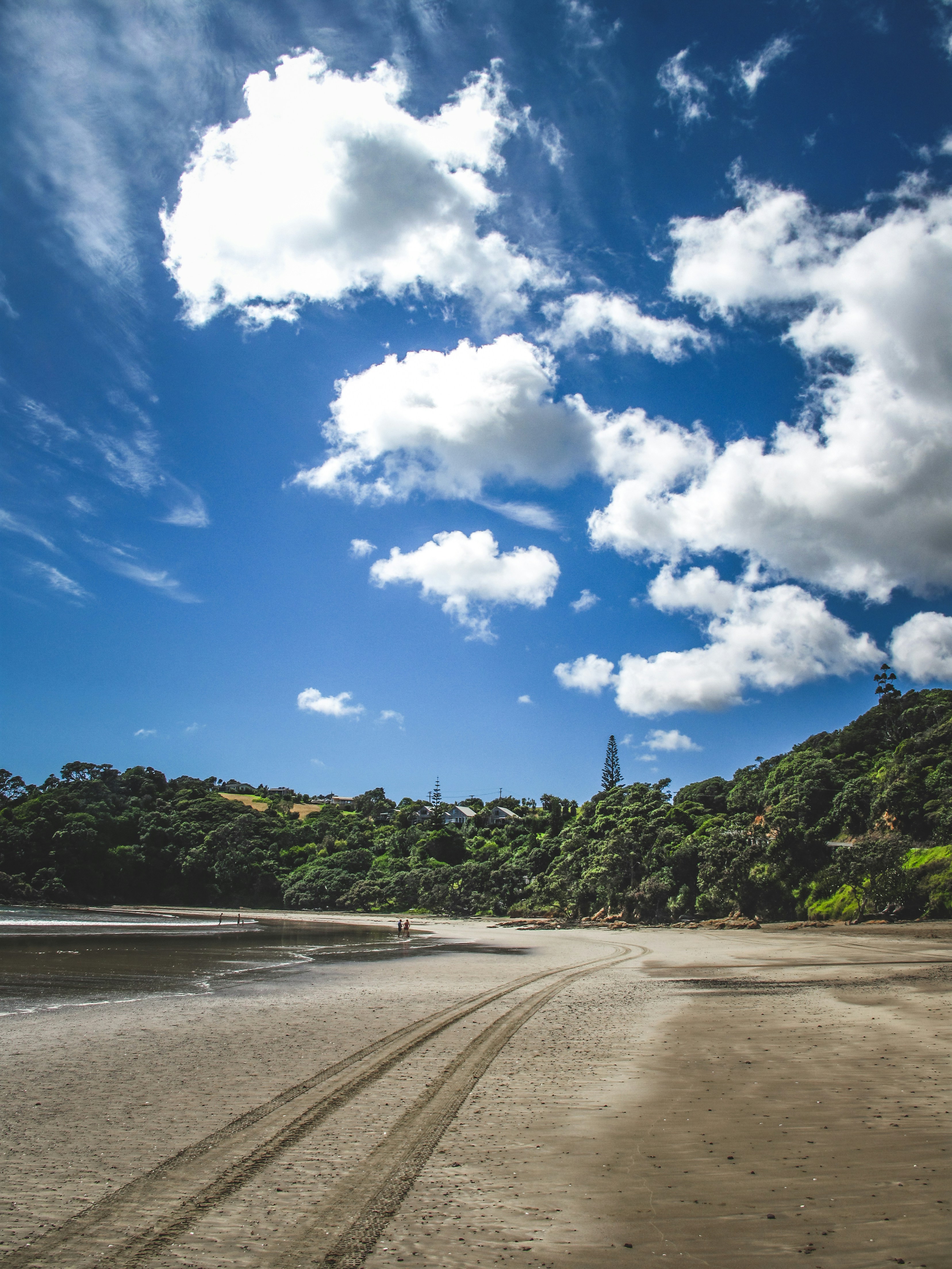 A sandy beach under a blue sky with clouds photo – Free Blue Image on ...