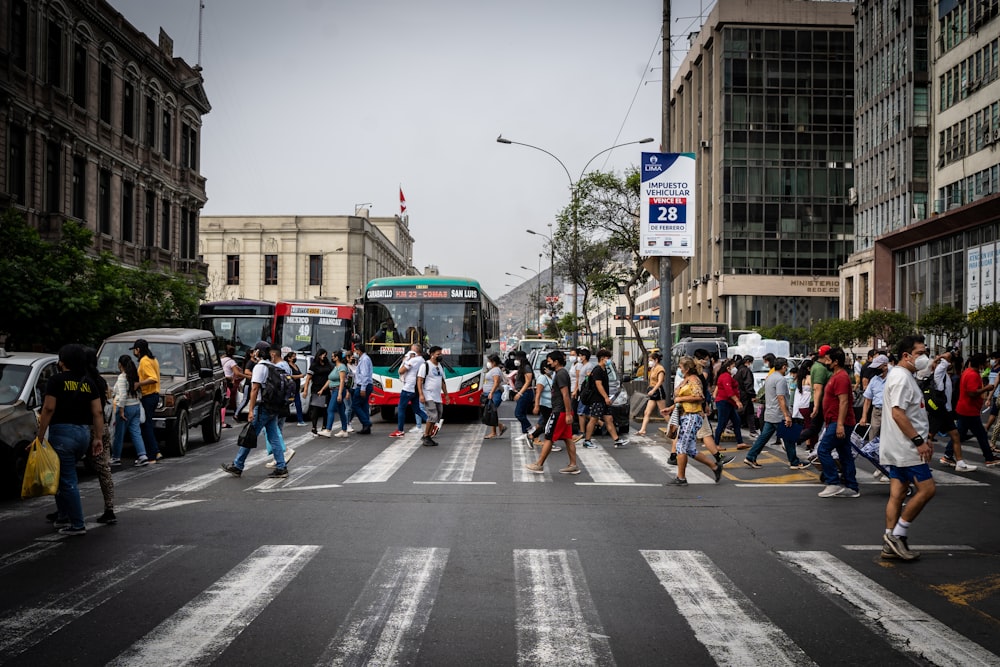 a large group of people crossing a street