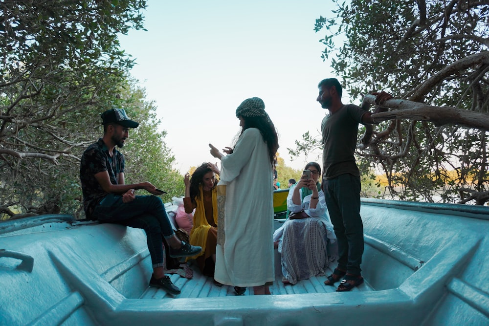 a group of people sitting in the back of a boat
