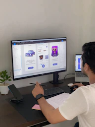 a man sitting at a desk in front of a computer