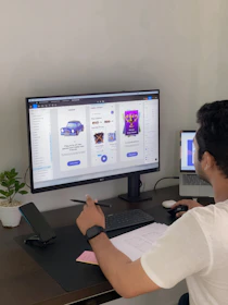 a man sitting at a desk in front of a computer