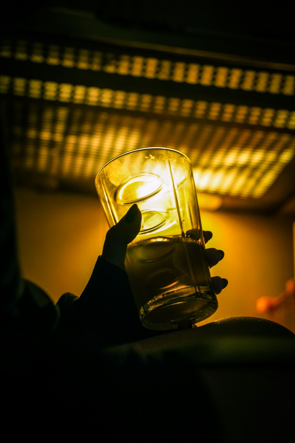 a person holding a glass of water in their hand