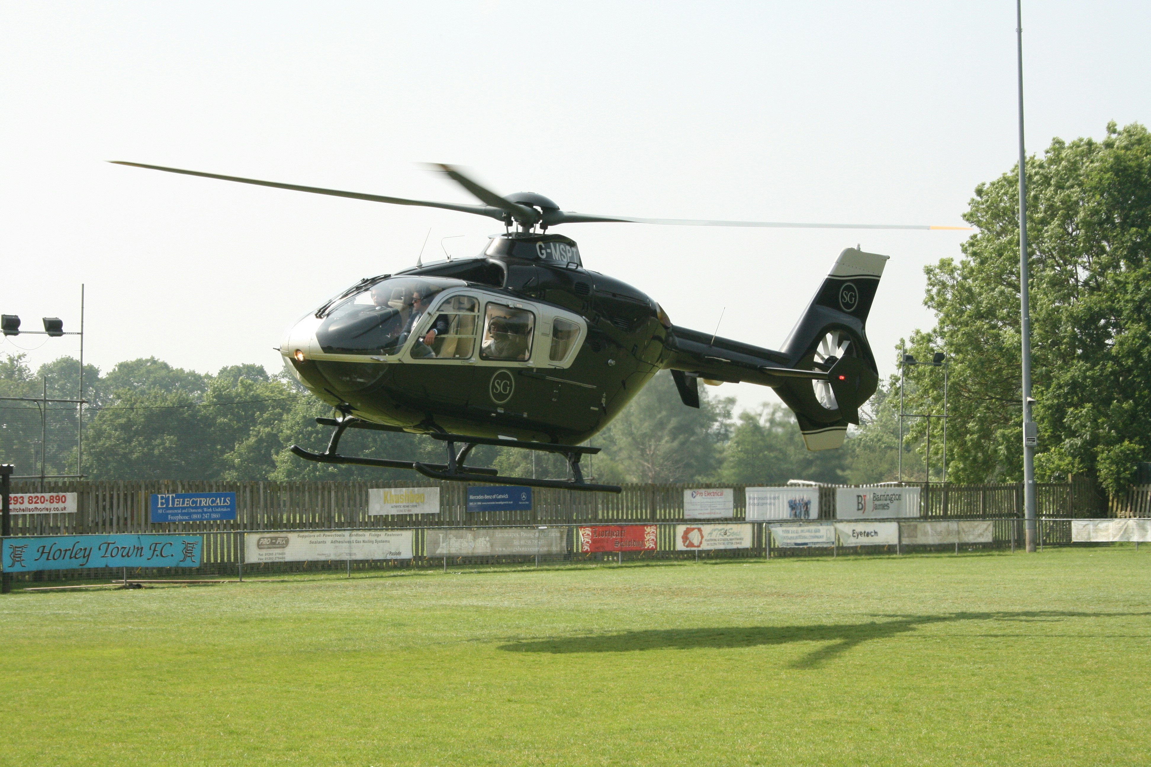 Helicopter landing on the football pitch at Horley Town Football Club