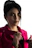Close-up of a customer wearing a coral-rose pink accessory from Roseverve, with a minimalist black and white background.
