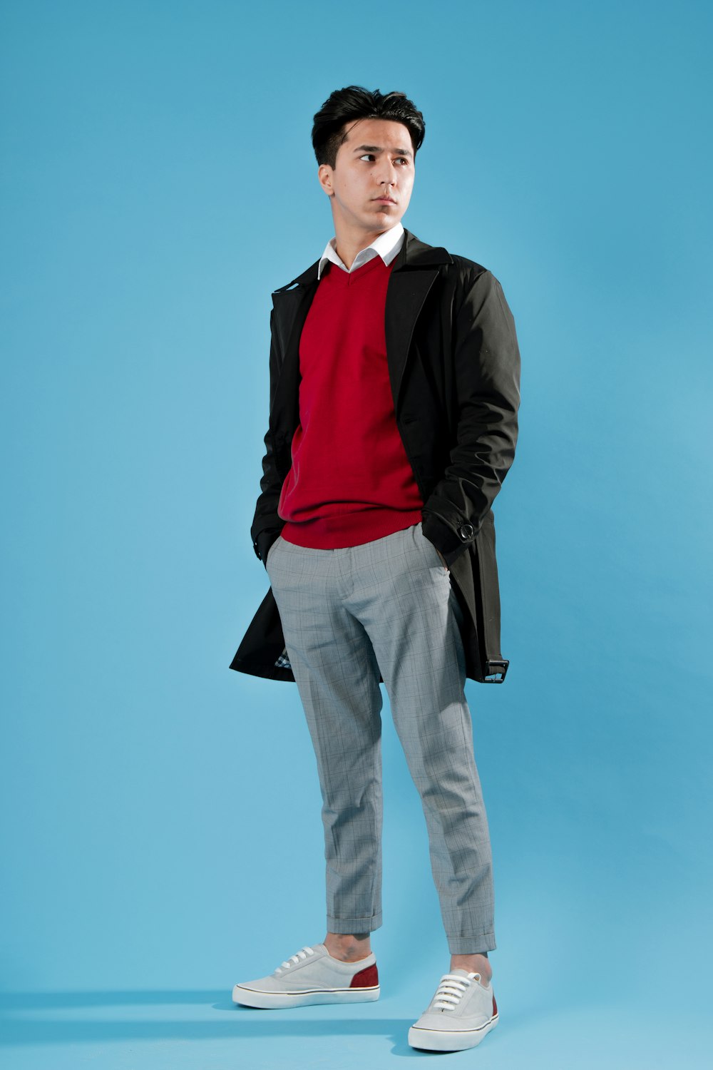 a man in a red shirt and grey pants