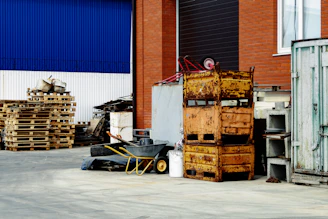 a pile of wooden crates sitting next to a building