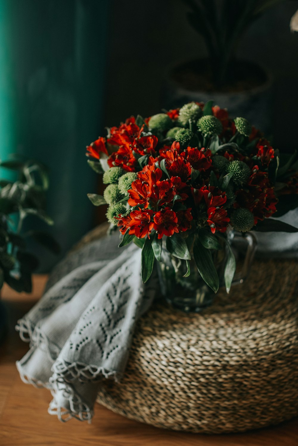 a bouquet of red flowers sitting on top of a table