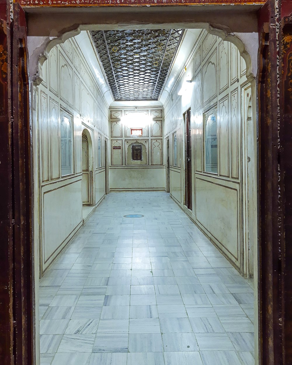a long hallway with a tiled floor and walls