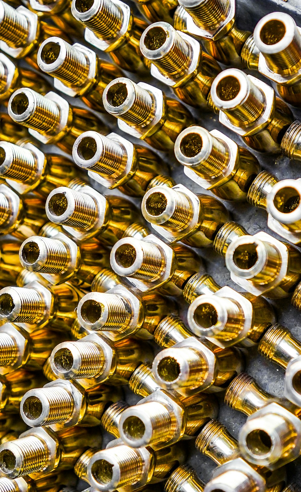 a bunch of yellow and silver hoses lined up together