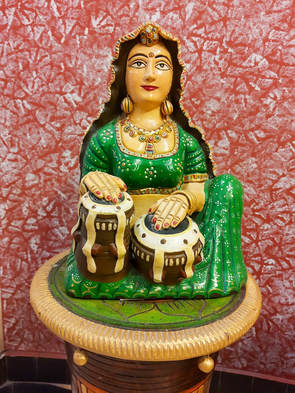 a statue of a woman sitting on top of a table