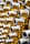A close-up view of several threaded cylindrical metal objects, possibly bolts or connectors, arranged in a pattern. The metal surfaces have a shiny, polished appearance with golden and silver tones. The image has a shallow depth of field, creating a blurred effect in the background.