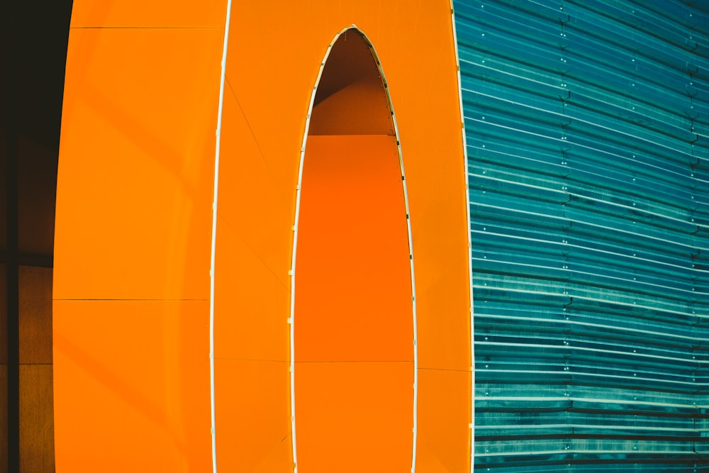 a close up of a large orange object near a building