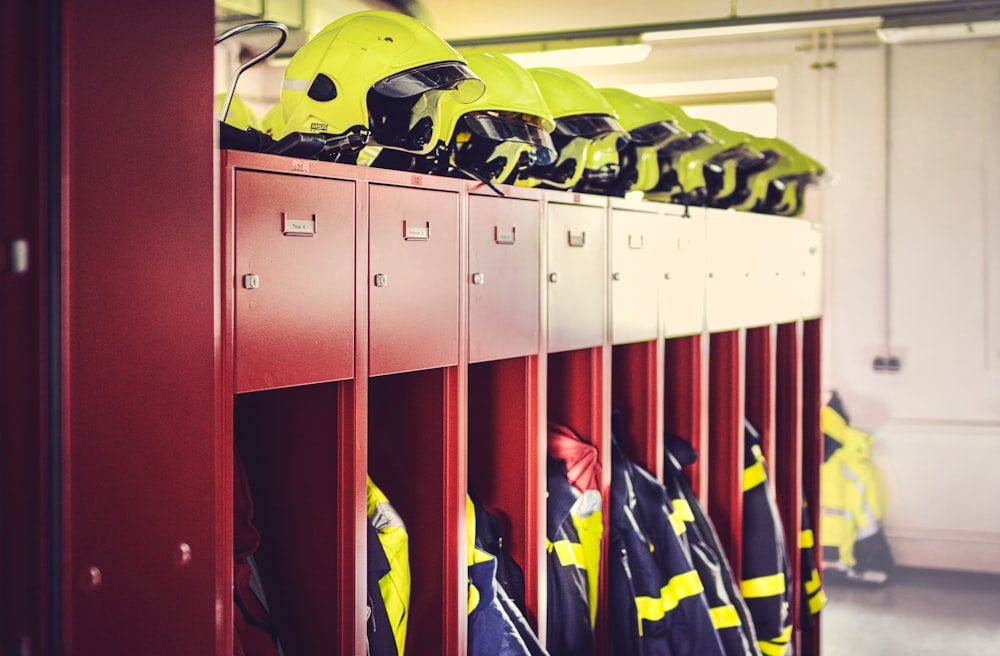 a row of lockers with helmets on top of them