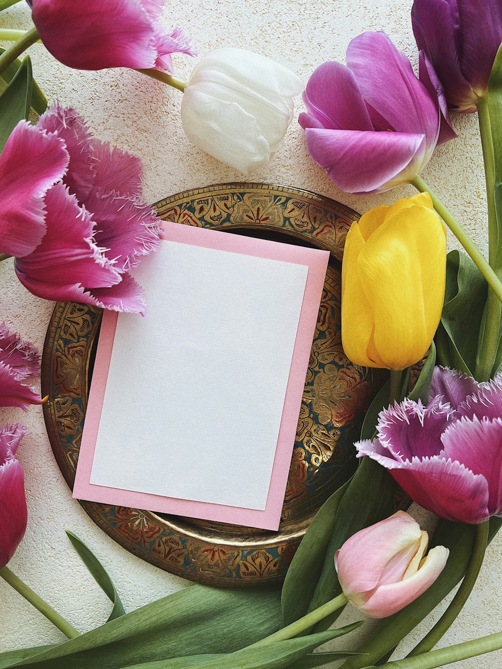 a plate with flowers and a card on it