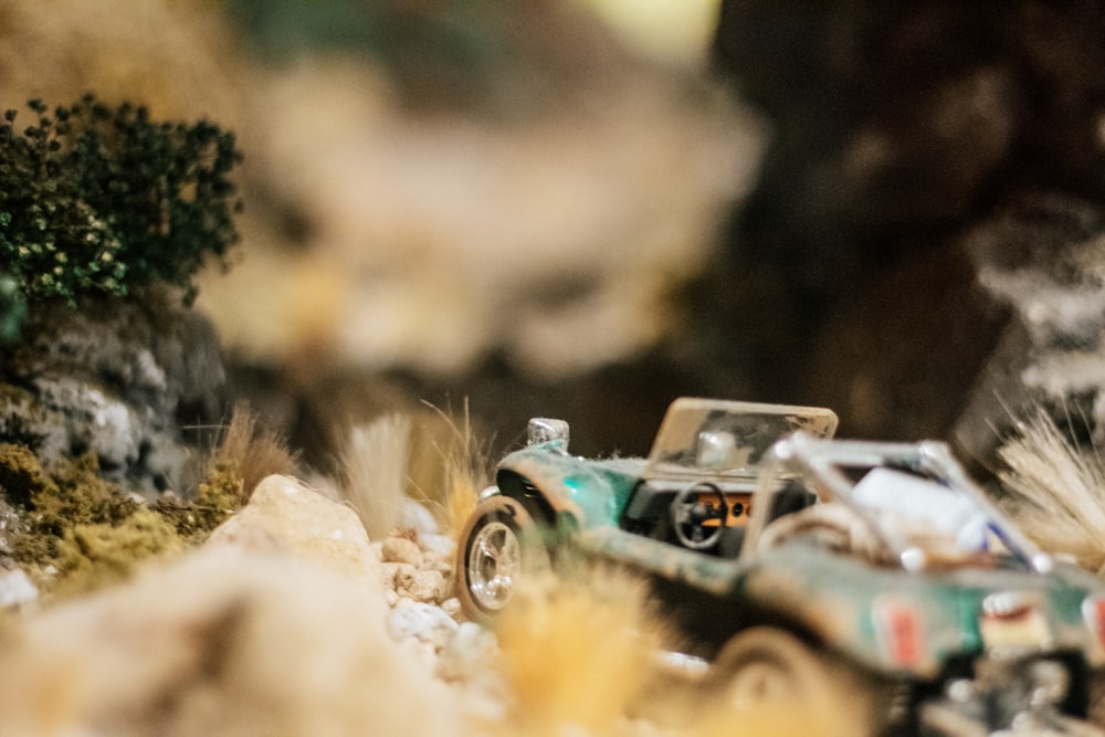 a toy car is driving through a rocky terrain