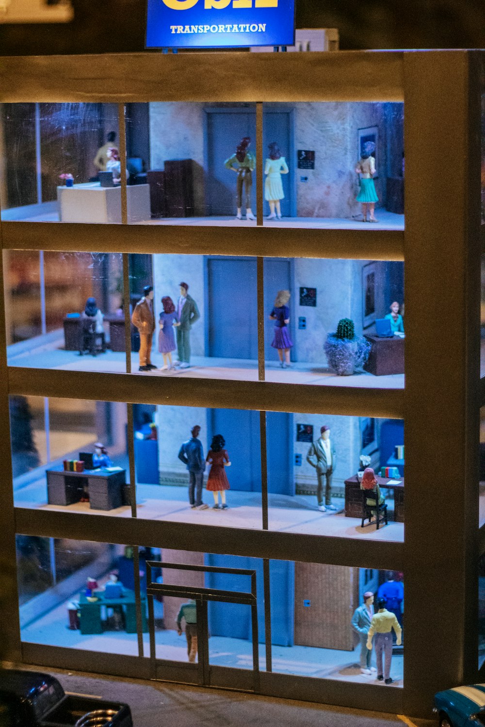 a display case filled with miniature people in a building