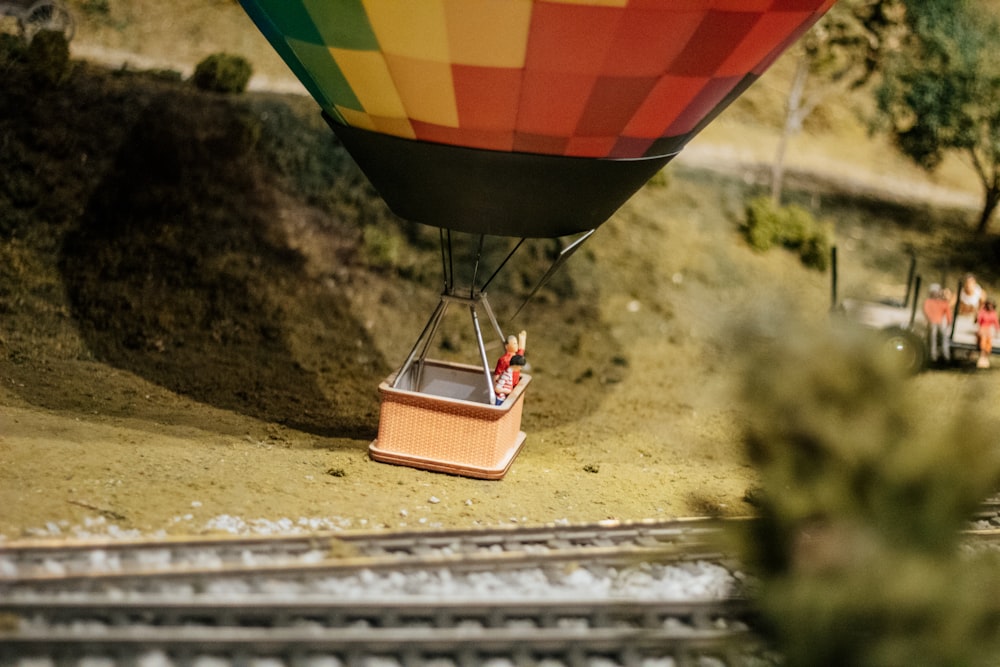 a hot air balloon is flying over a train track