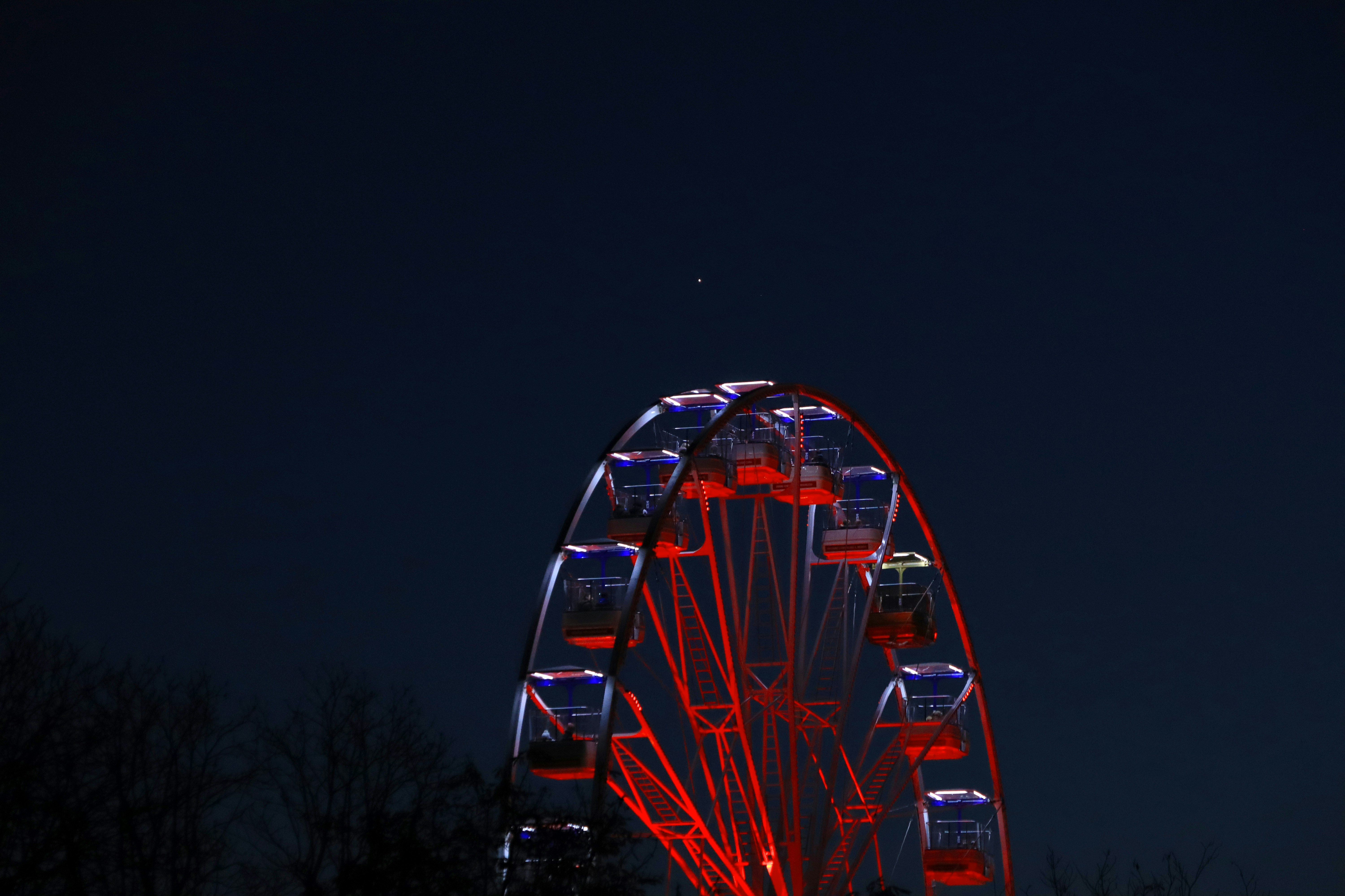 a large ferris wheel lit up at night