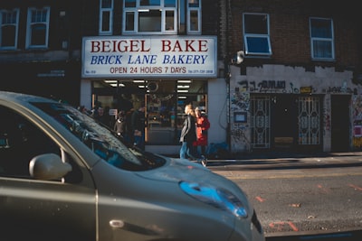 a car parked in front of a brick lane bakery