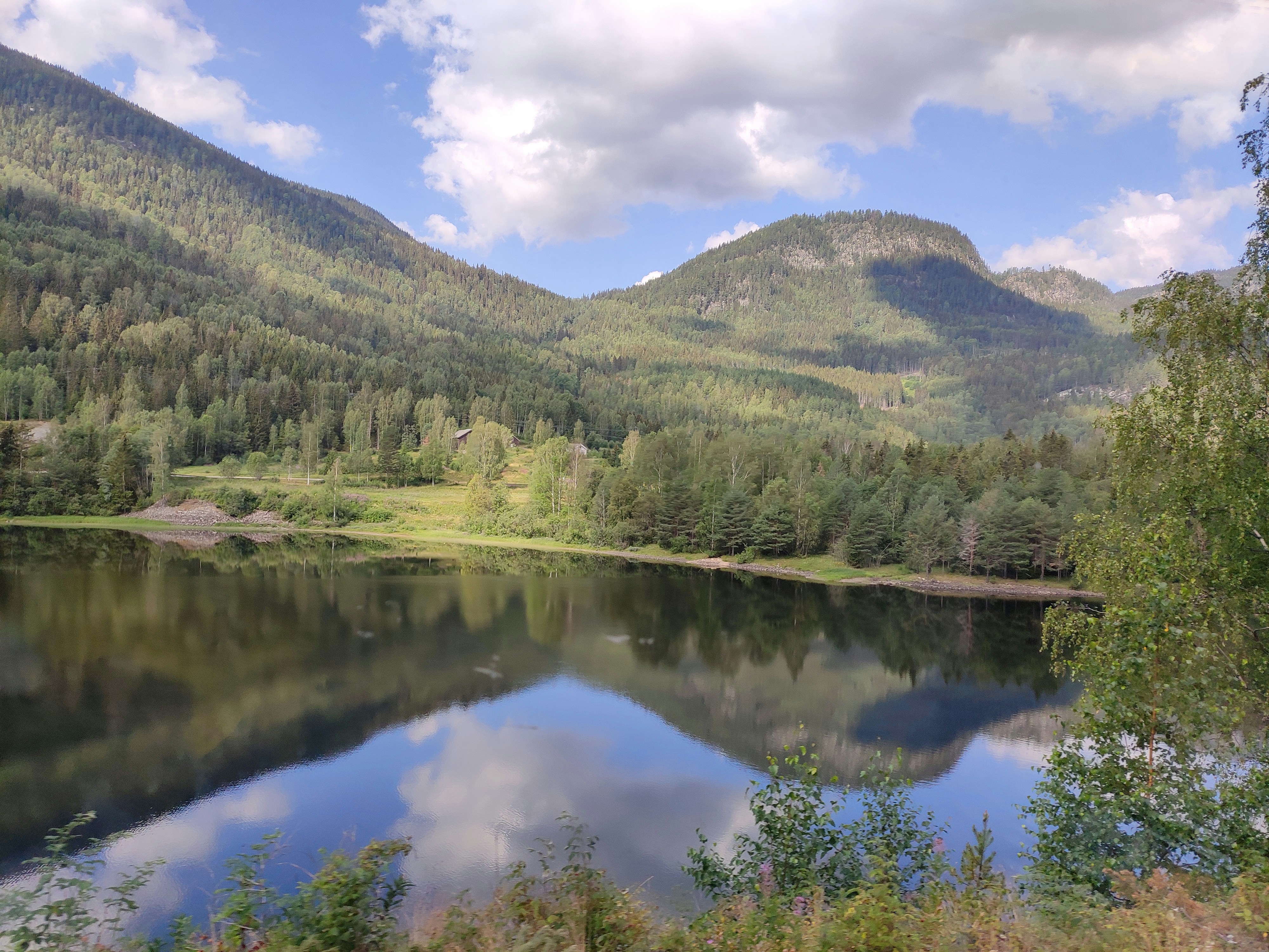 a lake surrounded by mountains and trees