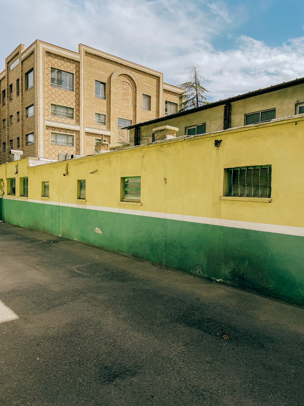 an empty parking lot with a building in the background