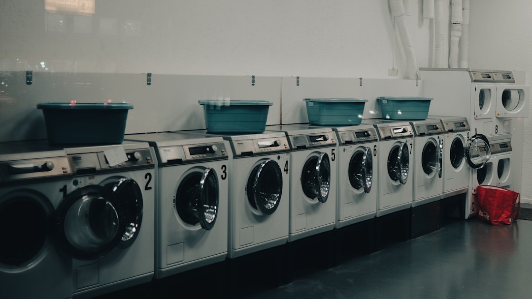 Shot through the window of a wash salon late at night... a row of washers and dryers in a room