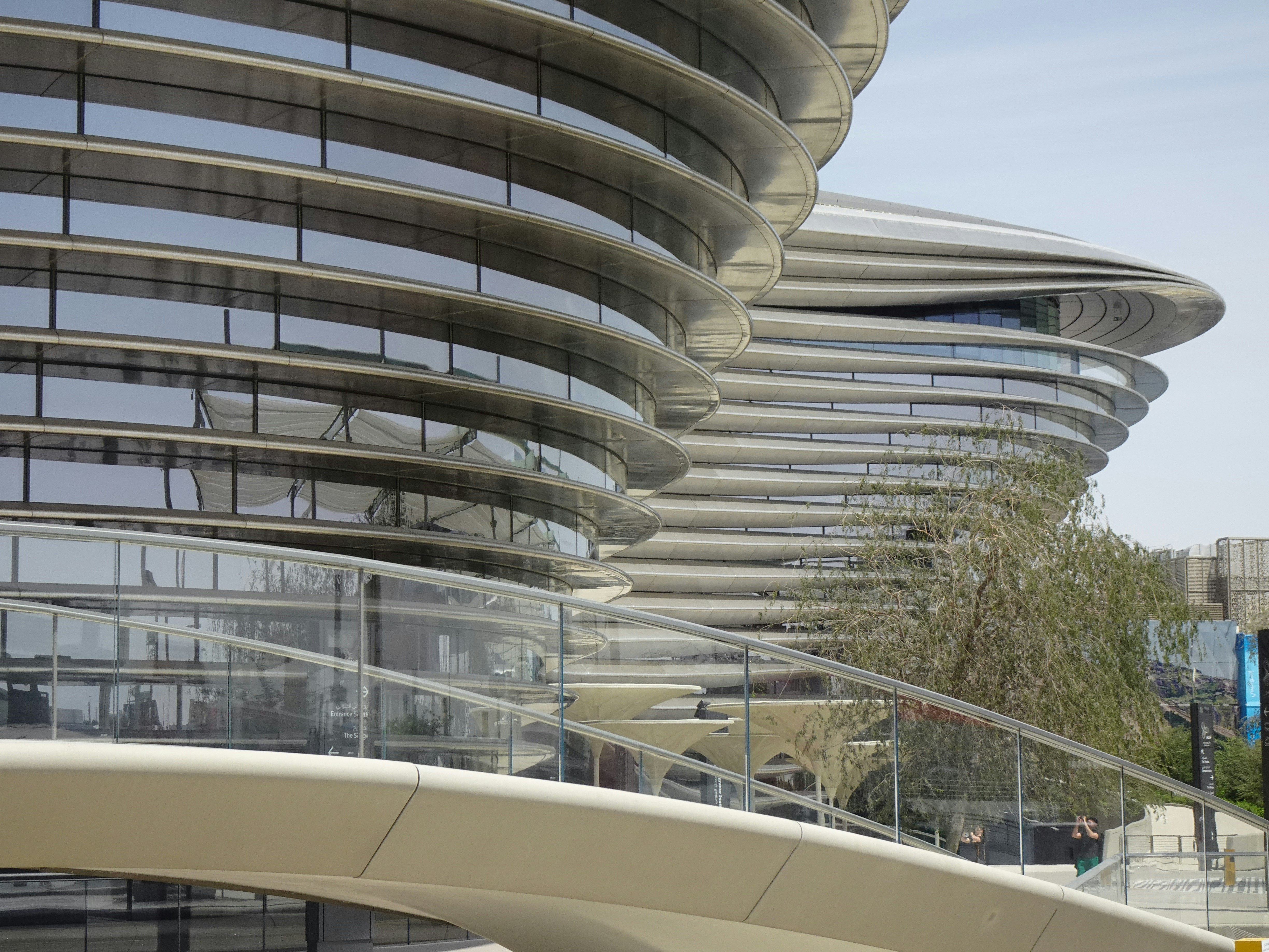 A large building with a curved walkway in front of it photo – Free ...