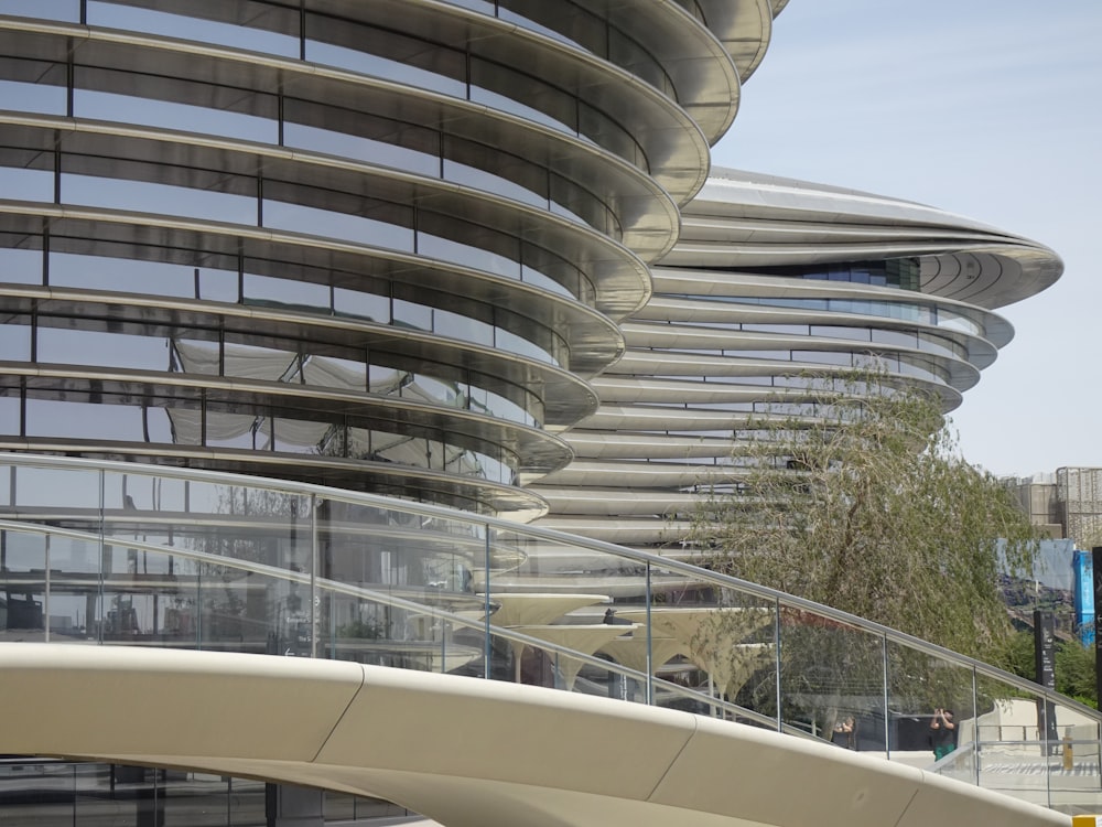 a large building with a curved walkway in front of it