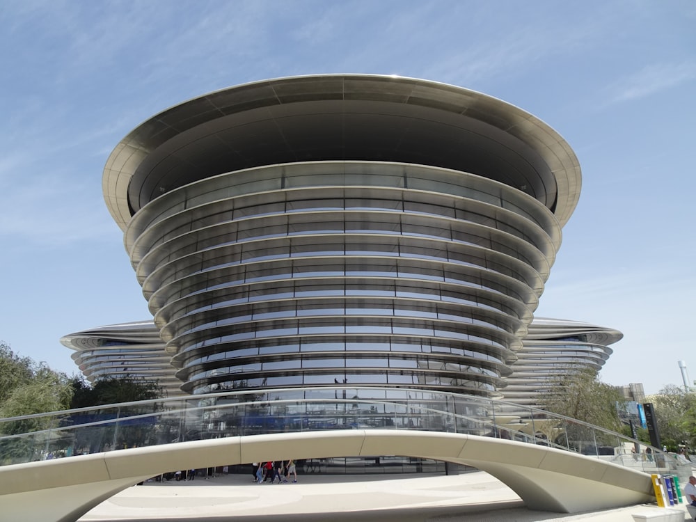 a large building with a curved roof and a walkway