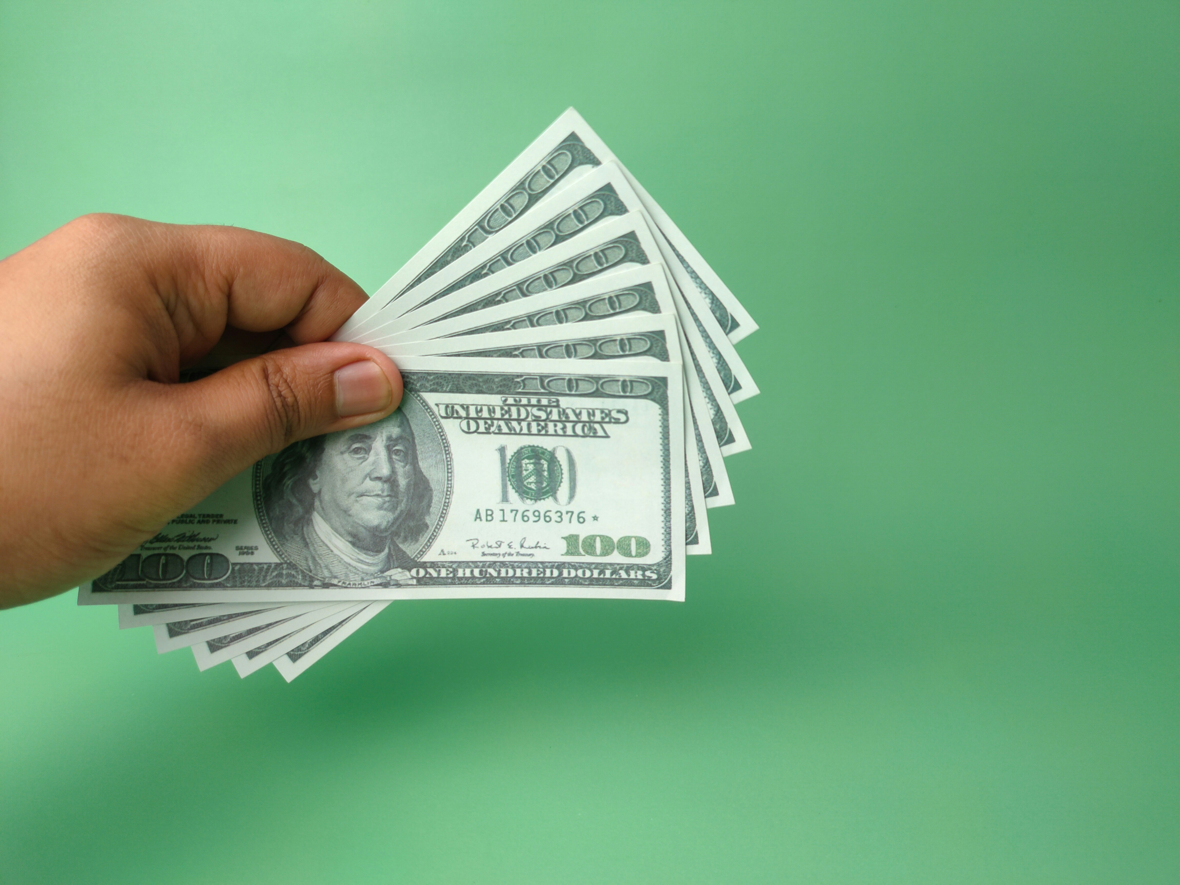 Hand holding banknotes with copy space.