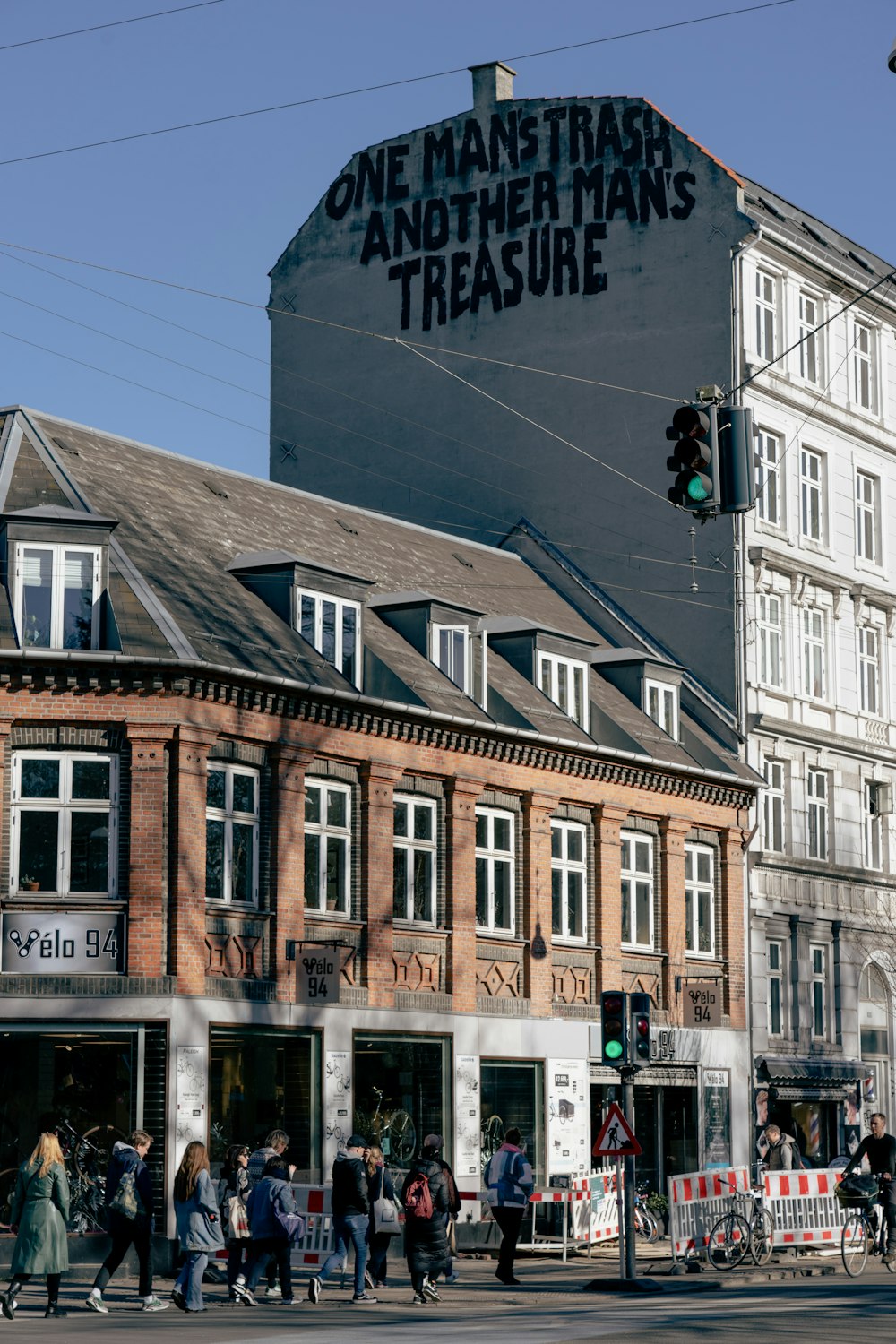 a group of people crossing a street in front of a building