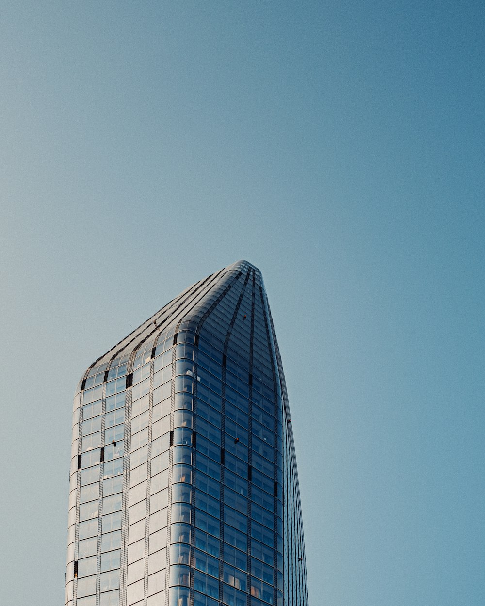 a very tall building with a sky background