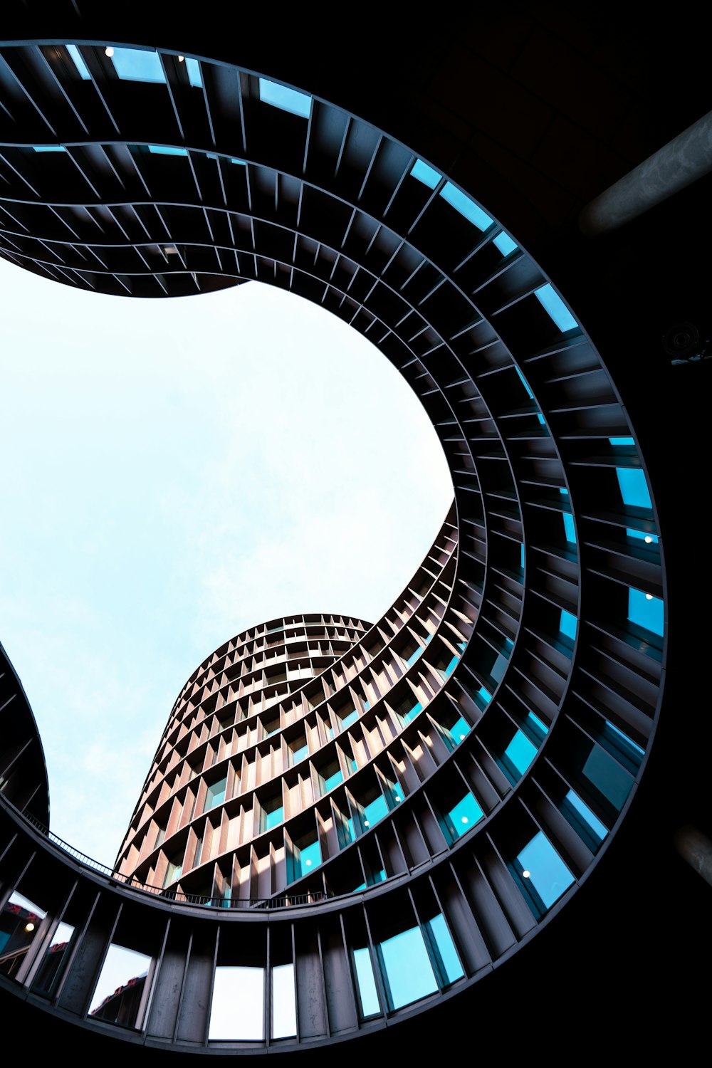 looking up at a tall building through a circular window