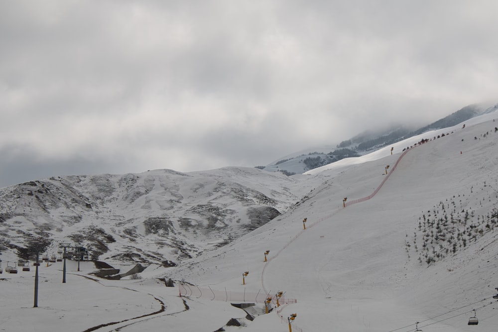 a snow covered mountain with a ski lift going up it