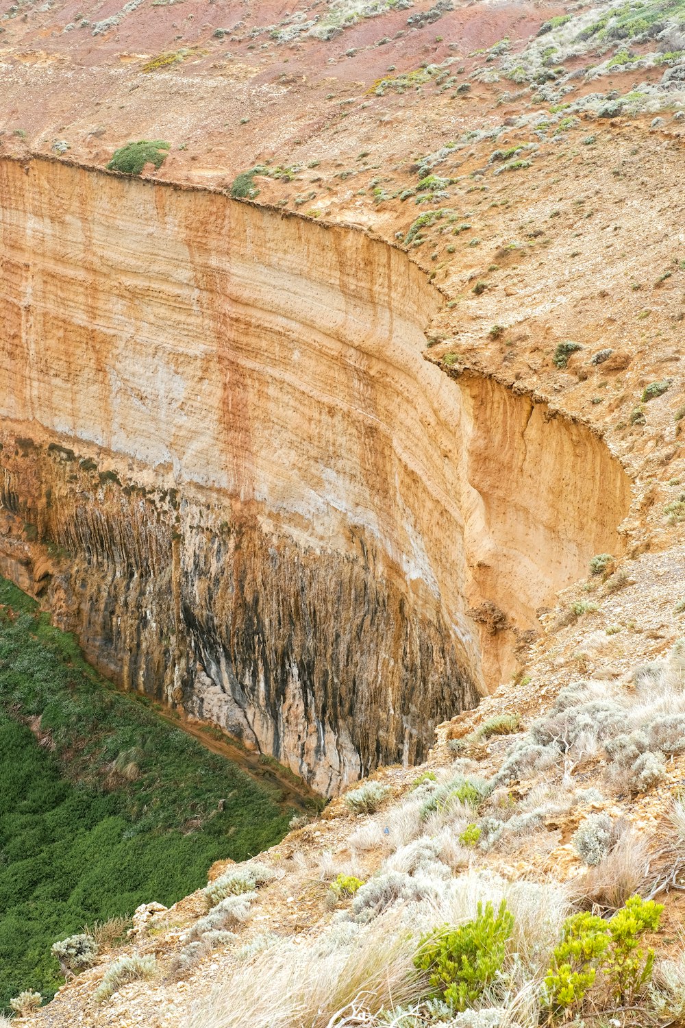 a large cliff with a very steep cliff face