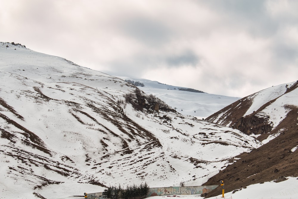 a snow covered mountain with a road going through it