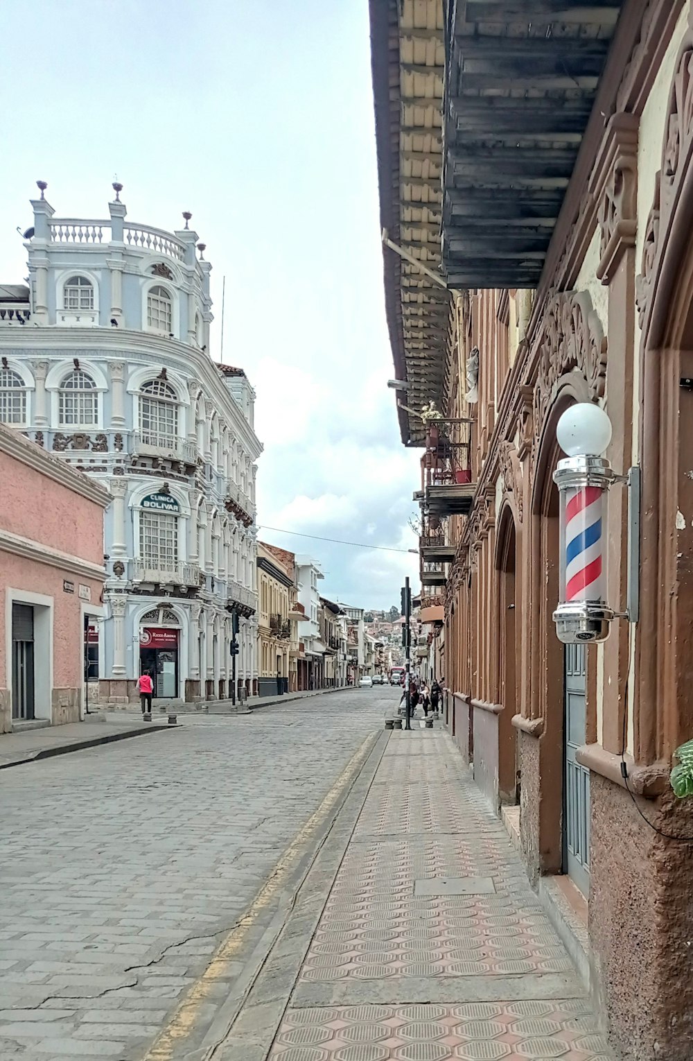 a cobblestone street lined with old buildings