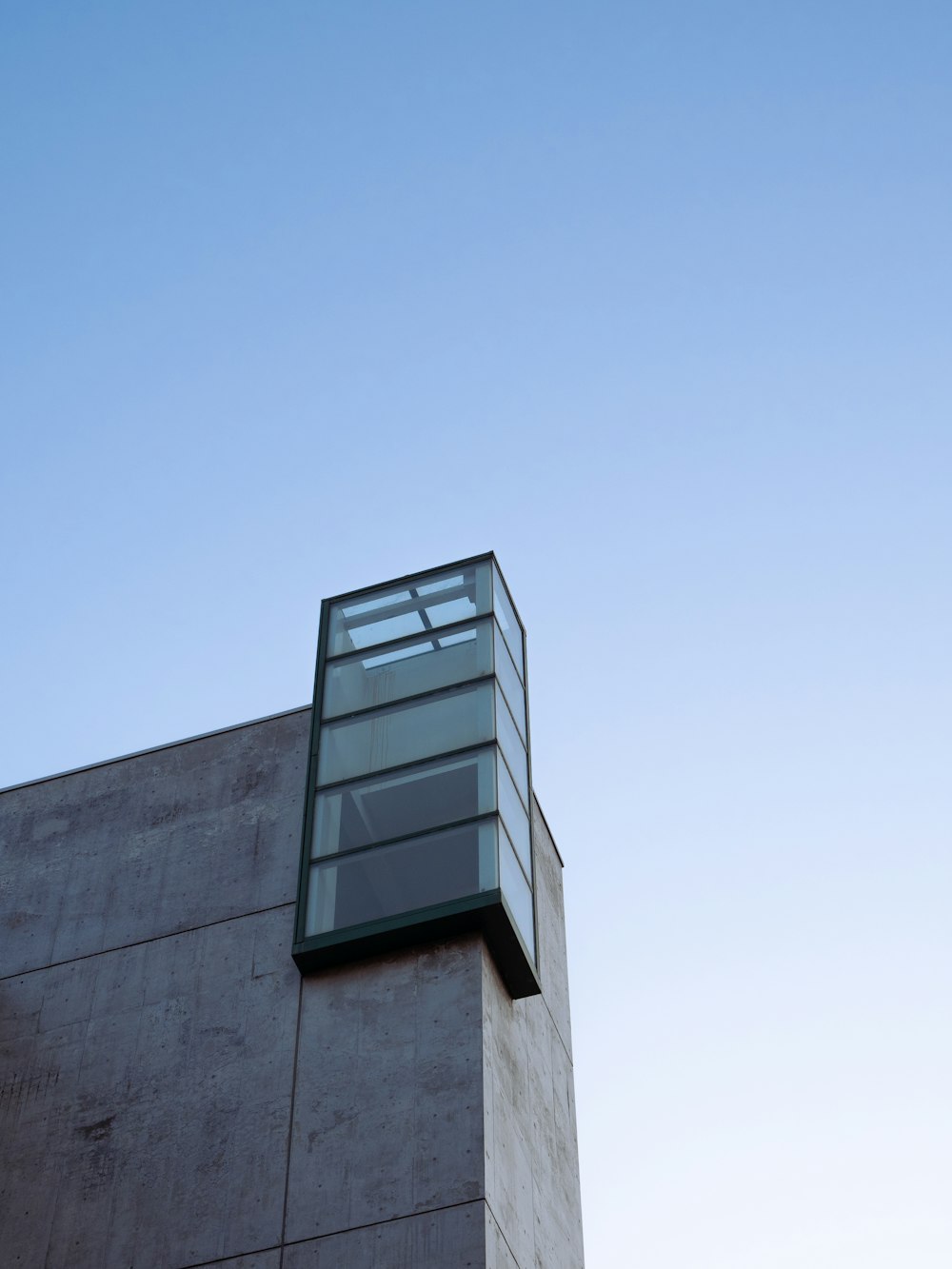 a tall building with a glass window on top of it