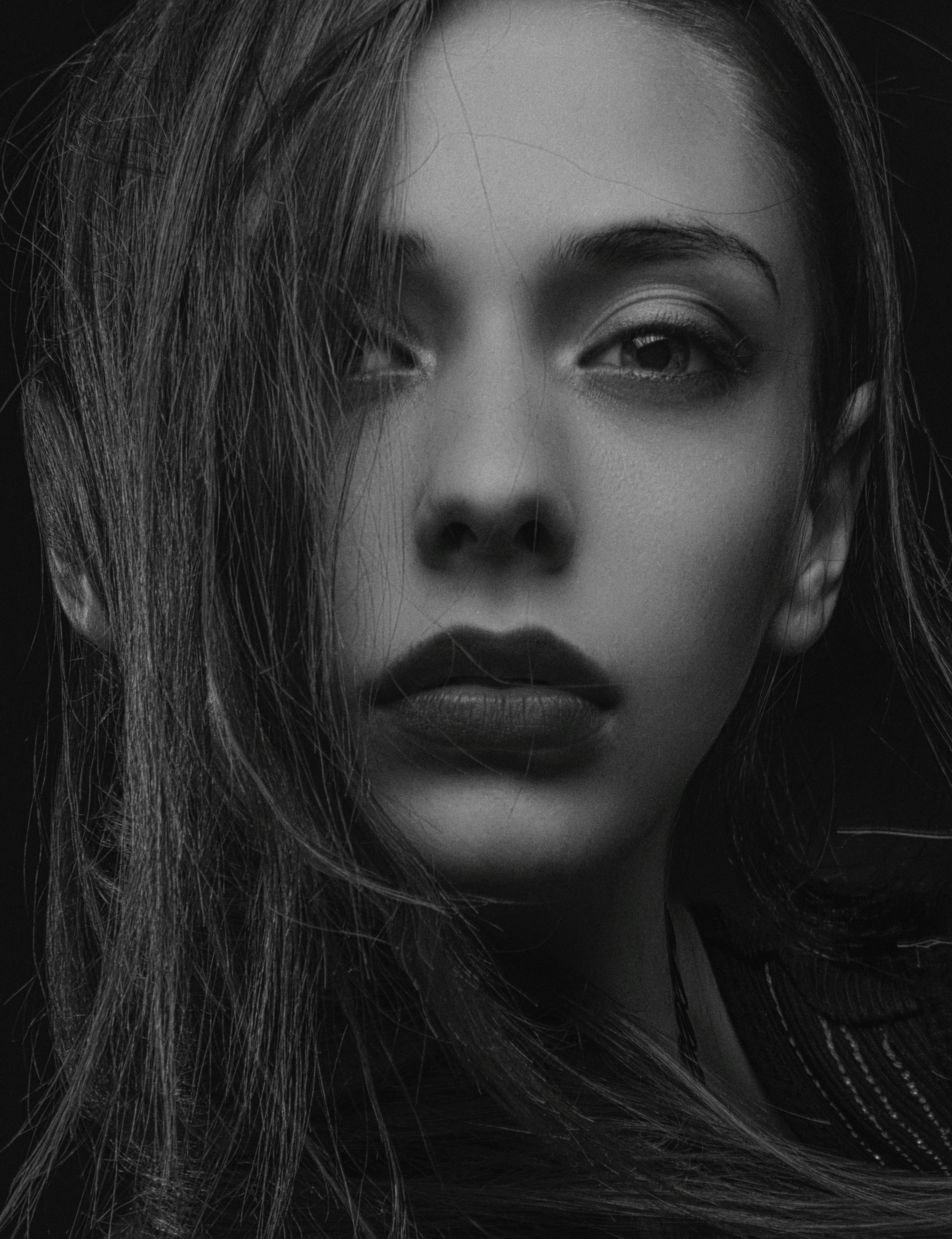 a black and white photo of a woman with long hair