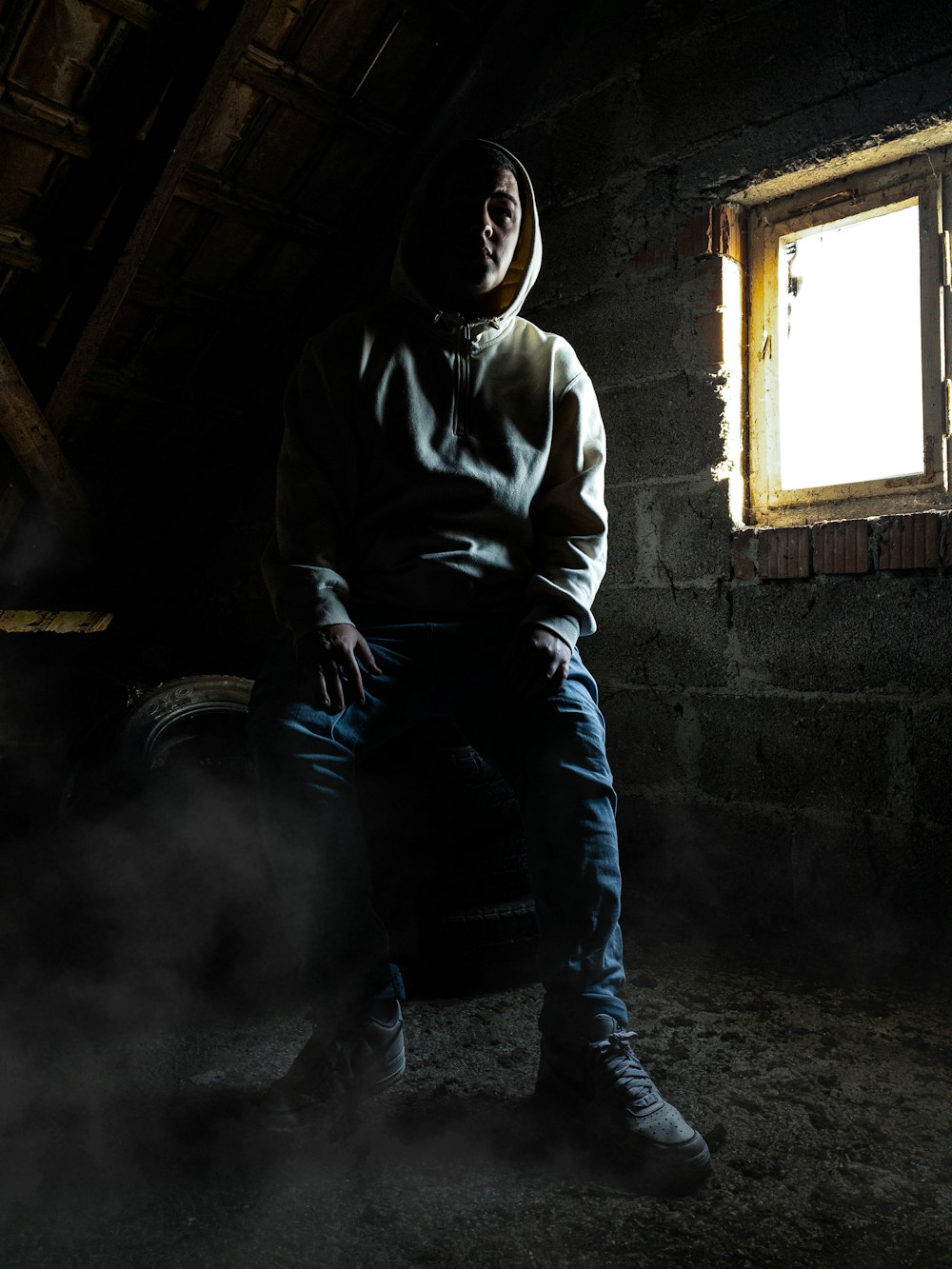 a man sitting on a chair in a dark room