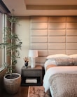 A serene bedroom showcasing modern furnishings and soft textiles.