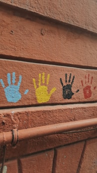a close up of a wall with hand prints on it