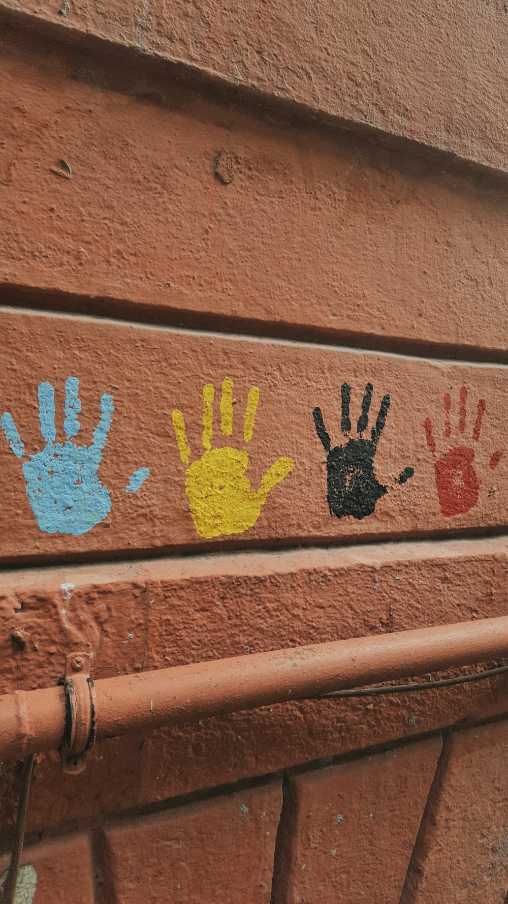 a close up of a wall with hand prints on it