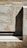 A textured surface with a mix of rough and smooth areas, showing a combination of light and shadow. The surface appears to be made of wood or a similar material with visible grains and markings, and a solid geometric shape casts a shadow across the surface.