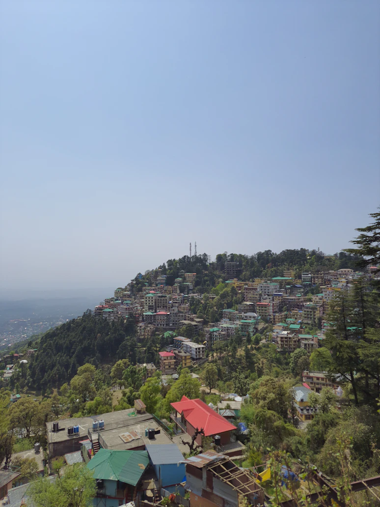 McLeod Ganj monastery streets with Dhauladhar backdrop