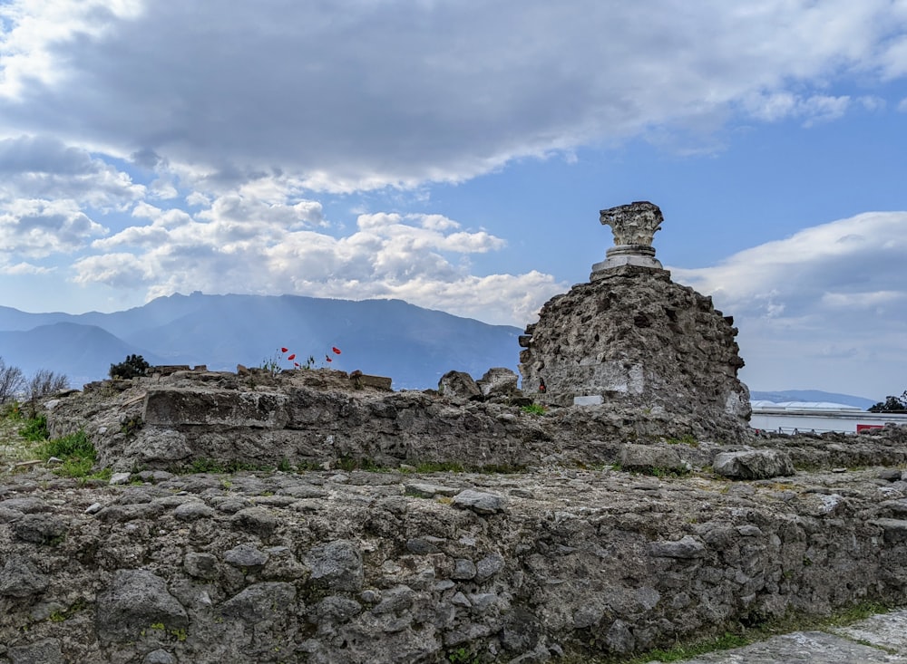 a stone structure with a clock on top of it