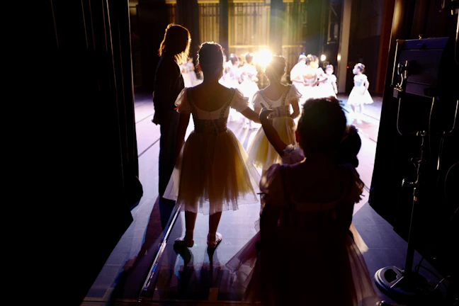 Contestants waiting nervously backstage, preparing for their moments in the spotlight.